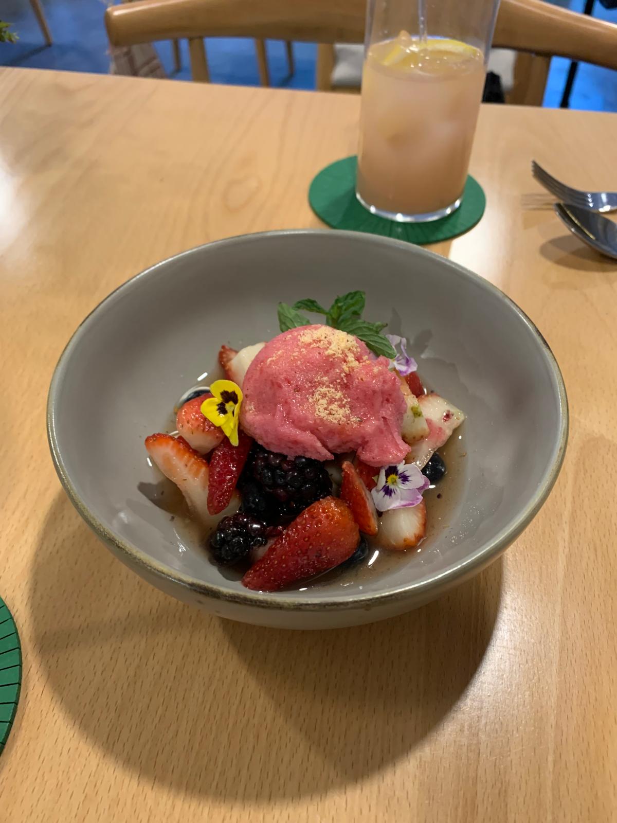 A bowl filled with berries and strawberry sorbet